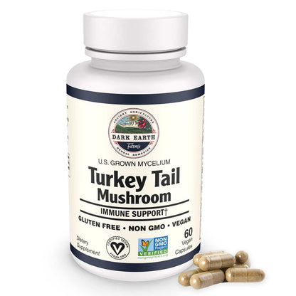 An image of a bottle labeled Dark Earth Farms Organic Turkey Tail Mushroom Capsules, featuring a blue and yellow label with the brand name and product information. The bottle contains 60 vegan capsules, each filled with 1000mg of turkey tail mushroom powder, a popular immune defense supplement.  The supplement is certified gluten-free and GMP certified, ensuring high quality and safety standards