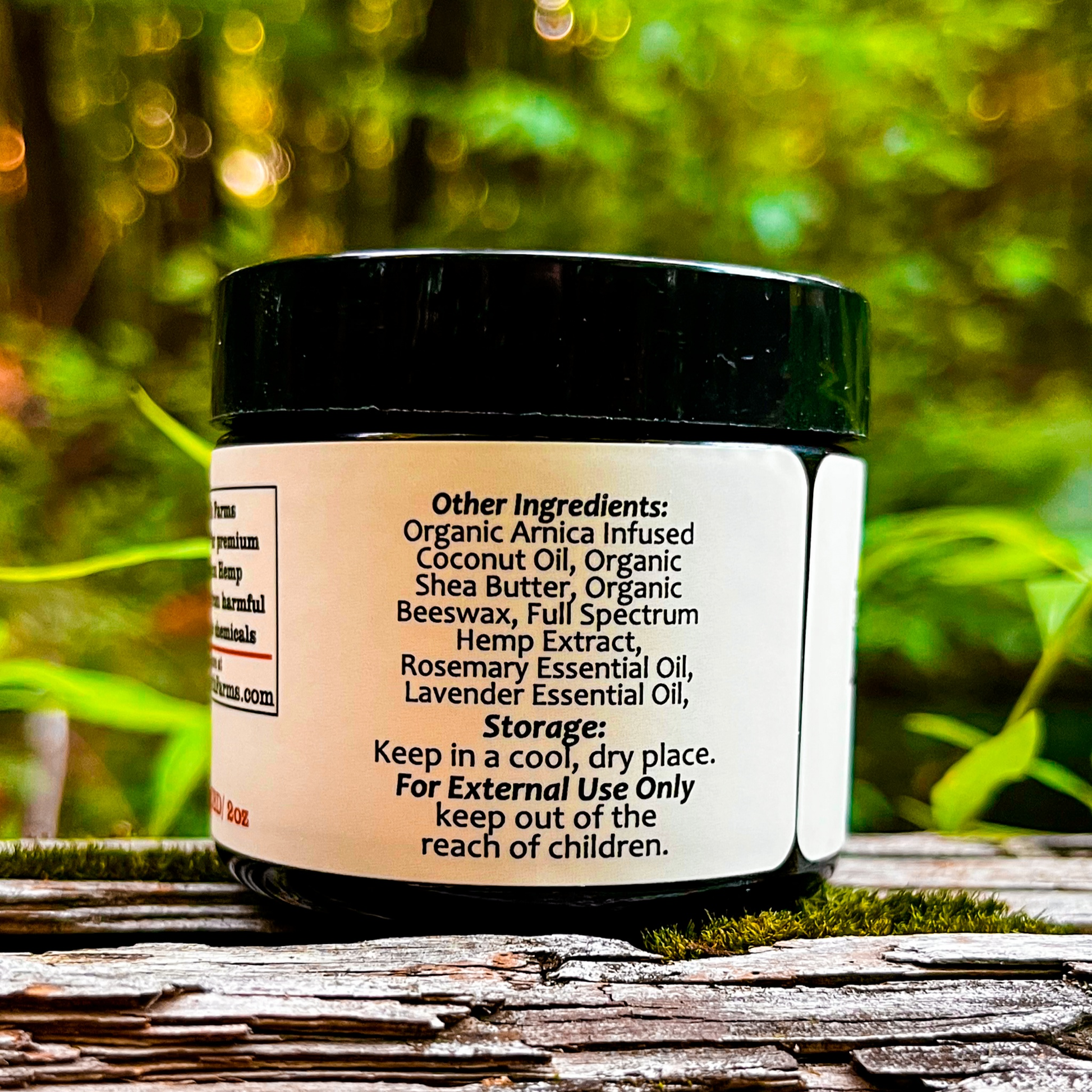 An image of a small jar labeled Dark Earth Farms Full Spectrum Hemp Topical, featuring a green and yellow label with the brand name and product information. The jar contains 2000mg of CBD cream with terpenes and cannabinoids, designed for targeted relief from pain and inflammation. The jar is placed on a wooden surface, surrounded by hemp leaves, and the cream is shown oozing out of the jar, ready for application.